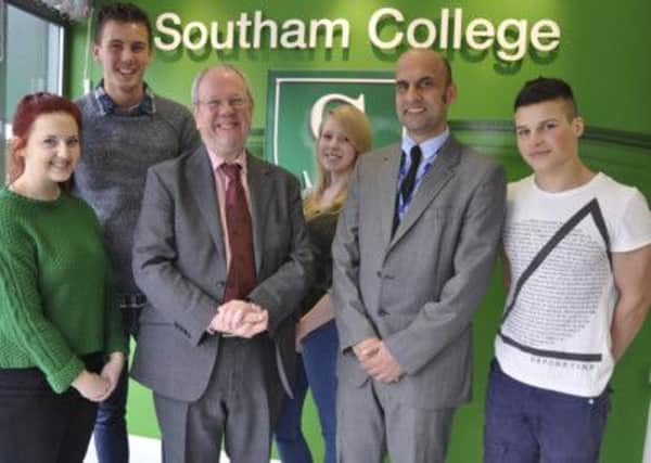 Lord Faulkner with pupils at Southam College and headteacher Ranjit Samra.