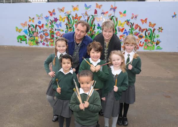 Pupils at St Anthony's Primary School have been working with artist Colin Yates this week on making wooden plaques which have now been put together to form a mura lon the school wall. Pictured with Colin and some of his artists is Head Teacher Mrs. Jane McSharry.
MHLC-04-03-13 School mural Mar20