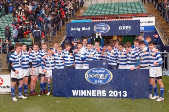 Warwick School under-15s celebrate their Daily Mail Cup success as the rain continues to fall at Twickenham.