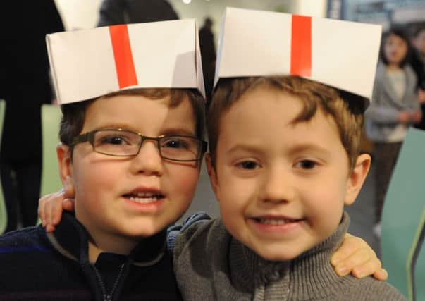Samuel Dunbar three, left, and brother Kyle, five, wearing papermakers' hats.