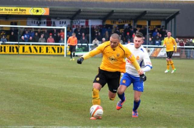 Matty Dodd brings the ball clear of Banbury goalscorer Michael Hopkins during Mondays clash at the New Windmill. MHLC-01-04-13 Brakes Banbury Apr10