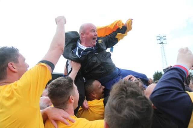 Manager Paul  Holleran is hoisted aloft at the final whistle after Brakes clinched the Southern Premier League title at Bideford. Pictures: Gary Learmonth