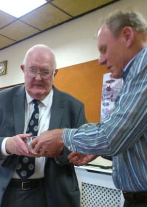 Cllr John Grantham is presented with his gift by Wellesbourne parish council chairman David Close.