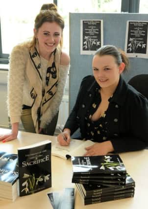 MHLC-08-05-13 Author May30
 Sam Dickens,Author and student is signing copies of her book for  Alice Walsh, Sacrifice at the Warwickshire College.
The event has been organised by events management pupils.