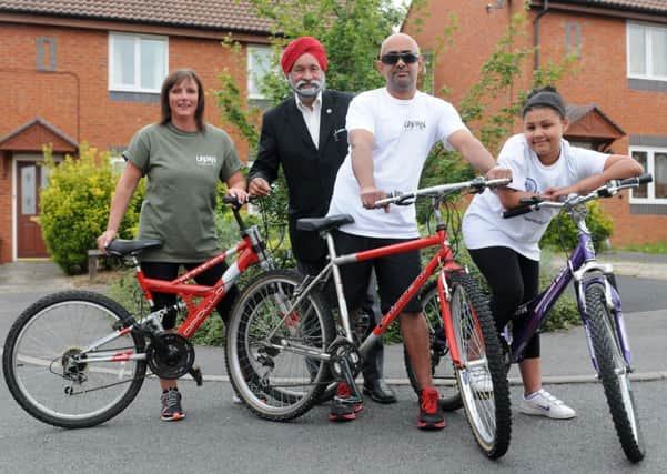 MHLC-25-06-13 triplet cyclists Jun92
Pictured,Cllr Mota Singh,Lisa Beck, her partner Bhupinder Mann and her daughter Lia Hayles are doing the Gilly Mundy cycle ride (6.5 miles around south Warwickshire) on a triplet bike (with three sets of pedals that have to be pedalled at the same time and pace).