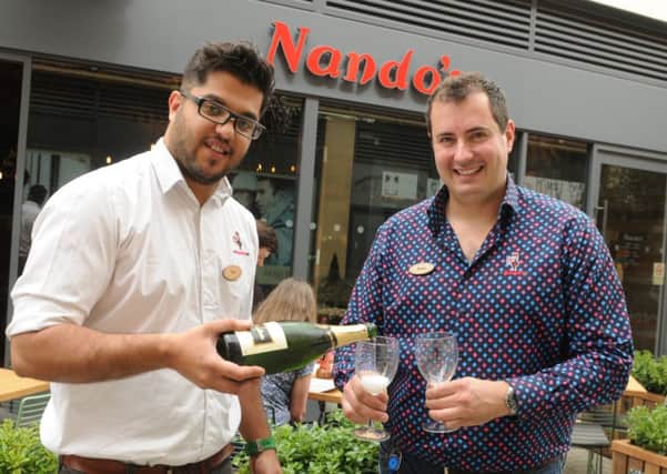 MHLC-10-07-13 Nandos Jul47 
The opening of Nandos in Regent Court,Leamington Spa.
Pictured, from the left,Taz Hussain (Manager) and Ross Dyke (supporting manager),Celebrates the Opening of New  Restaurant.