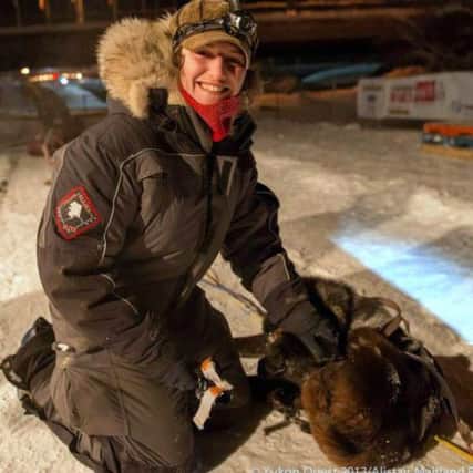 Leila dog-handling at the Yukon Quest in Alaska.