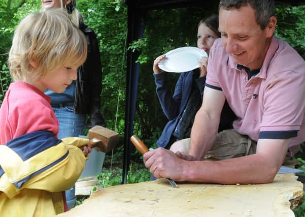 MHLC-22-06-13 Foundry fair Jun45 
Foundry Wood is held a community woodland fair to mark the wood opening to the public 
Pictures, of woodland crafts and tours.
Pictured,Fin (age five ) helping  Jinny Walker  carve the sign for foundry wood .