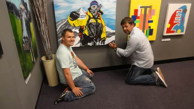 Mark Wood and artist Paul Jordan at Gallery 150 with the painting.