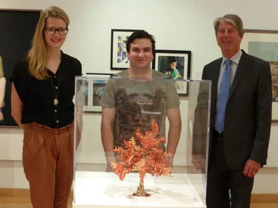 Lawrence Molloy (centre) and his artwork Banbridge Bonsai, with Alice Swatton of the Pump Room gallery and Cllr Stephen Cross.