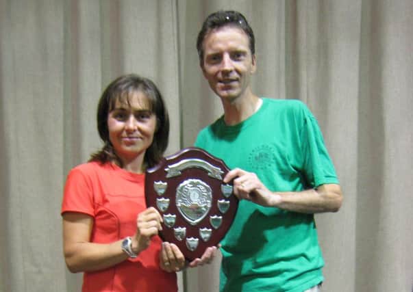 Spa Striders Carolyn Wilkinson is presented with the ladies inter-club shield by Kenilworth Runners Pete Bryan.