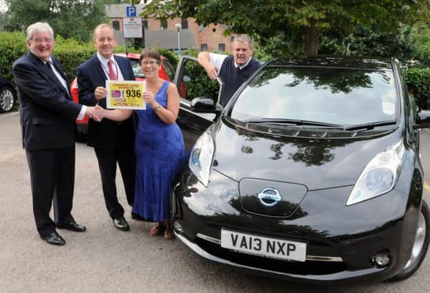 MHLC-23-08-13 Free sports Aug59
 Pictured from the left, Cllr Michael Coker (Portfolio Holder  Public Health and Community Protection), and Richard Hall (head of health and Community Protection), issued license for first electric powered taxi in the county to Annette Topliss and Bryn Jones (directors of prestige transfers ltd),at  Riverside House, Leamington Spa.
