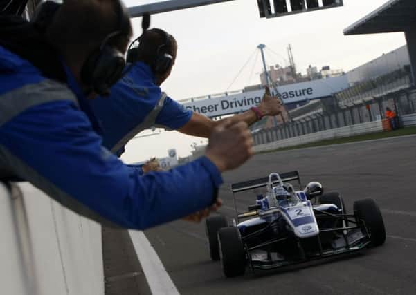 Jordan King crosses the line after securing the Cooper Tires British Formula 3 Championship.