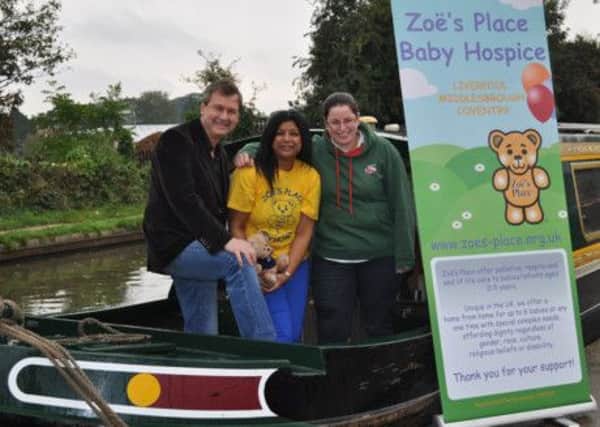 Kate Boats Rebecca Howes joins Dutch Van Spall in presenting the cheque to Muna Chauhan, corporate fundraiser for Zoes Place Baby Hospice.