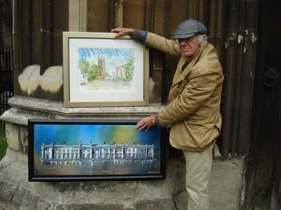 Leamington artist David Lewis at All Saints' church with his paintings of the church and Victoria Terrace.