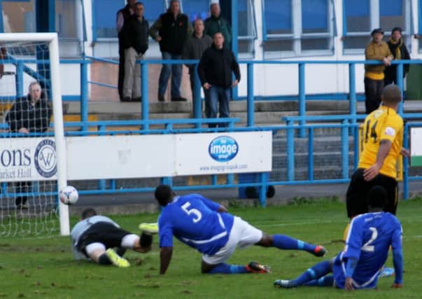 Stefan Moore beats the despairing dives of the Stalybridge defence and goalkeeper to cut the deficit at Bower Fold last Saturday. Picture: Sally Ellis