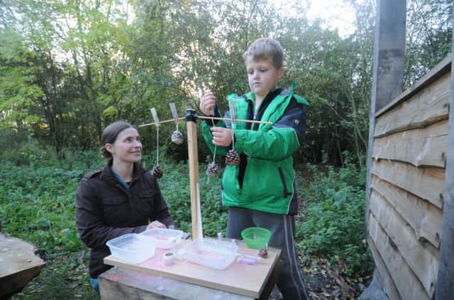 Adam Lothian, 8, one of the children at the workshop, with volunteer Jill Davis.