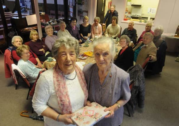 Pat Singh (right) receives a thank-you gift from Mavis Peace, who both ran the Radford Road Church coffee mornings, on the group's last meeting.