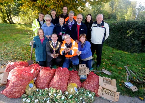 The Mayor of Southam Cllr Jason Ward was over-seeing the start of a bulb planting exercise on the recreation ground on Wednesday. CEMEX have purchased £300 worth of daffodil bulbs and over a tonne of bulbs were planted. The Mayor is seen with Andy Spencer from CEMEX. Also pictured is Southam Gardening Club Chairman Ann Forster (kneeling, right) plus other Gardening Club members, CEMEX volunteers and members of the community.
MHLC-30-10-13 Southam Bulbs Oct89