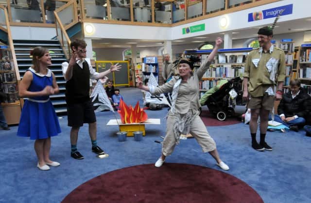 Performers bring Swallows and Amazons to life for children at Leamington library.