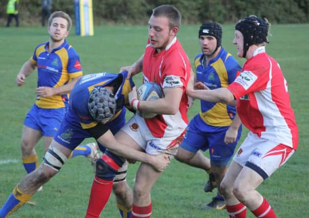 Tom Nicholson gets stuck in to prevent the progress of a Whitchurch attacker during Saturday's Midlands One West clash at Glasshouse Lane.