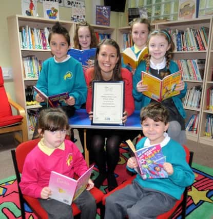 Alice Wyatt from Warwickshire SLS presented a Library Award to Lillington Nursery and Primary School on Wednesday morning. She is pictured with children Brook 5, Leo 6 , Anthony 8, Daisy 10, Chloe 10 and Olivia 7. MHLC-06-11-13 Library Award Nov04