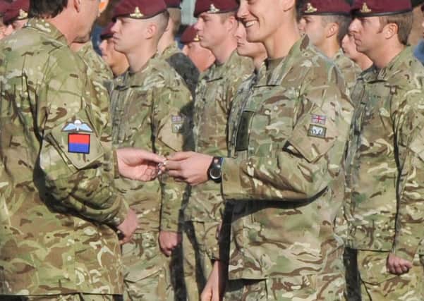 Captain Heather Stanning receiving her Operational Service Medal from Major General Robert Weighill.Picture by Kate Shemilt.C131536-7