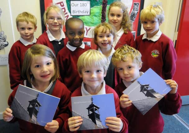 Pupils at the Dassett Primary School with their book.