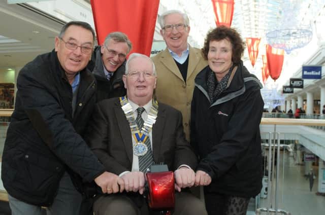 Leamington town councillors David Greenwood and Ann Morrison and town clerk Robert Nash with Peter Barton (sitting), president of the Rotary Club of Royal Leamington Spa and Geroge Dick, fundrasing chairman of the Shopmobility scheme.