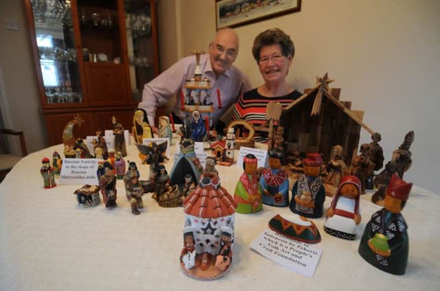 Rev John Carrier and his wife with some of the nativity sets.
