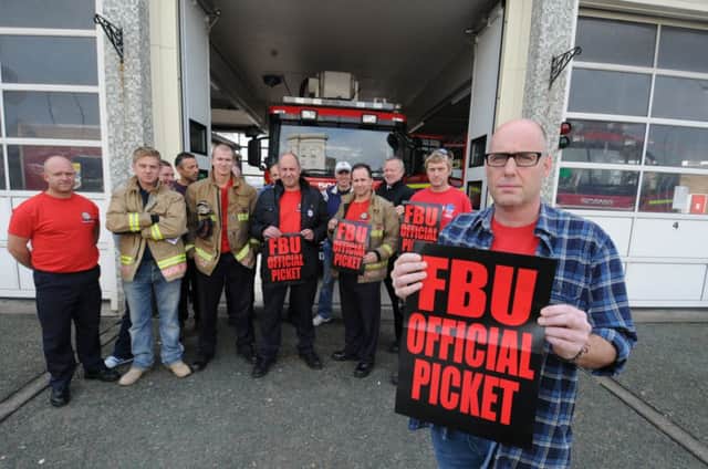 Members of the Warwickshire branch of the Fire Brigades Union, with branch secretary Marcus Giles, staging industrial action at Leamington fire station earlier this year.