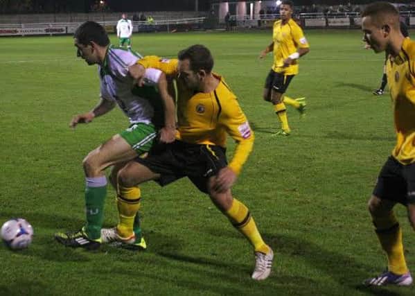 Lee Moore challenges for possession with The Villagers Danny Clarke. Picture: Sally Ellis