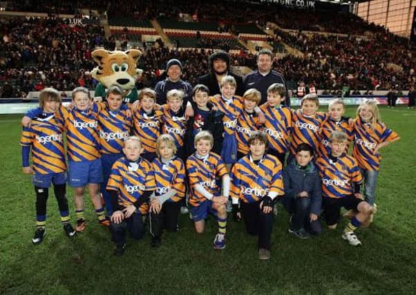 OLs under-tens are pictured on  the Welford Road pitch with Leicester Tigers Logovii Mulipola.