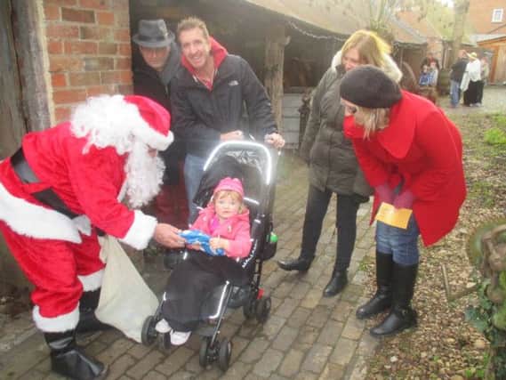 Father Christmas meets some visitors to Chedham's Yard in Wellesbourne.