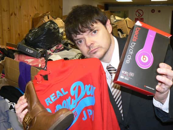 Warwickshire trading standards officer Simon Cripwell with just a few of the many counterfeit items seized at Wellesbourne market.
