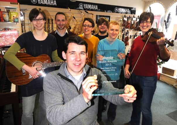Presto music shop in Leamington has won an award for Best Classical Music Instrument Shop in the UK from the Music Industries Association. M.D. Chris O'Reilly shows off the award with members of staff.
MHLC-10-12-13 Presto Dec40