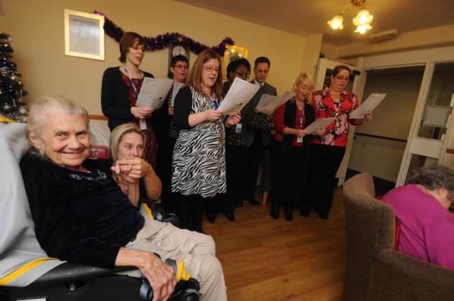 The Gridtones choir from National Grid employees perform Christmas songs for residents at Sycamore's care home in Sydenham.