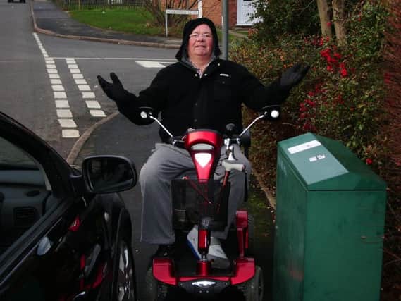 Whitnash man Bob Parkes, who is disabled, is pictured here unable to ride his mobility scooter along a pavement in Whitnash because of people parking their cars on the pavement.