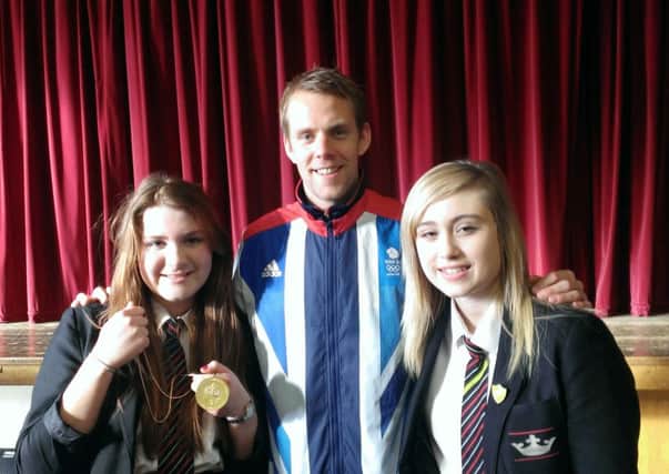 Olympic swimmer Ross Davenport with Kineton High School pupils Maisie Rollason and Molly McGrath.