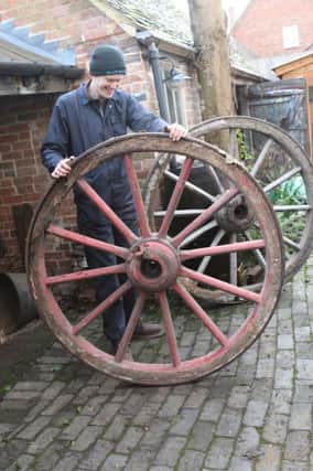 Mike Davies from wheelwrights restoration firm Acton Scott with the wheel at Chedhams Yard.