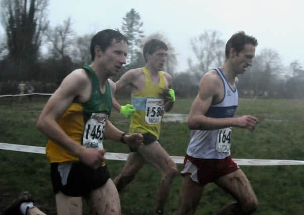 Leamington C&AC's Andrew Savery struggles through the worst of the conditions at Newbold Comyn. MHLC-25-01-14 Midlands XC Jan44