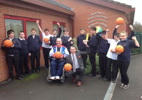 Paralympian Nigel Murray and Sainbury's Leamington store manager Ben Stanley deliver sports equipment to pupils at Round Oak School.