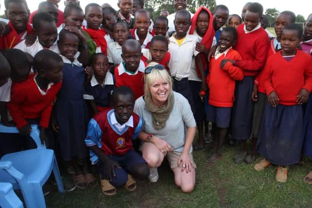 Suzie Ayling, manager of the Rose and Crown in Warwick, with children in Kenya.