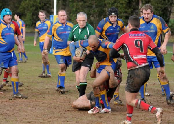 Nyle Beckett struggles to shake off the attentions of a tackler during Kenilworths Midlands One West clash with Hereford. Picture: Jass Lall