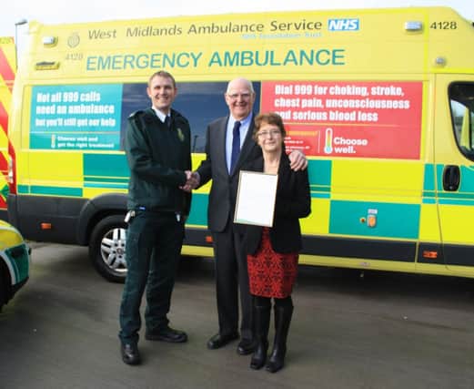 Long-serving community first responders Mick and Barbara Shepherd are presented with their letter of thanks by Martyn Scott, West Midlands Ambulance Services area manager for south Warwickshire.