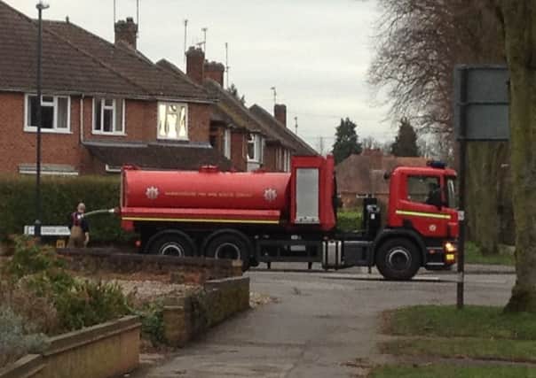 Firefighters stop at Montrose Avenue refill a water tanker to tackle the fire at Blackdown Hall in Sandy Lane nearby.