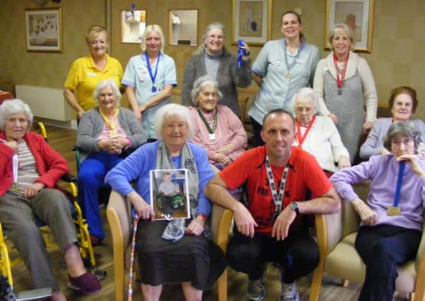 Waldemar Stezycki with staff and residents at Cubbington Mill care home and a picture of Patryk Nowak.