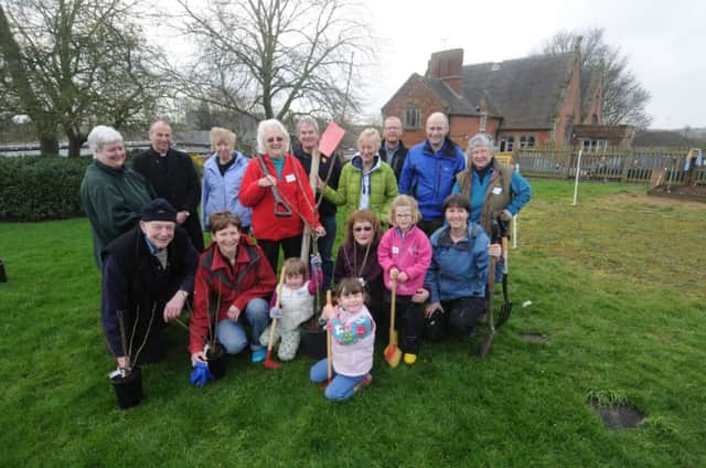 Pictured at the tree plant at Cubbington Primary School on Saturday are the Rev Graham Coles, headteacher Cathy Clarke, Mike Smith from Smiths Nursery, volunteer helpers and children.