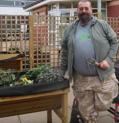 Peter Crane, a patient at the Central England Rehabilitation Unit in Warwick Gates, taking part in gardening activities.