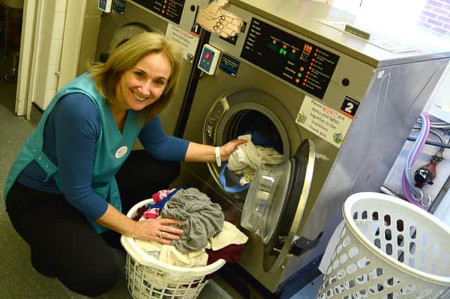 Christine Asbury, chief executive of the WCS Care Group, doing her laundry duties at Sycamore's care home in Sydenham.